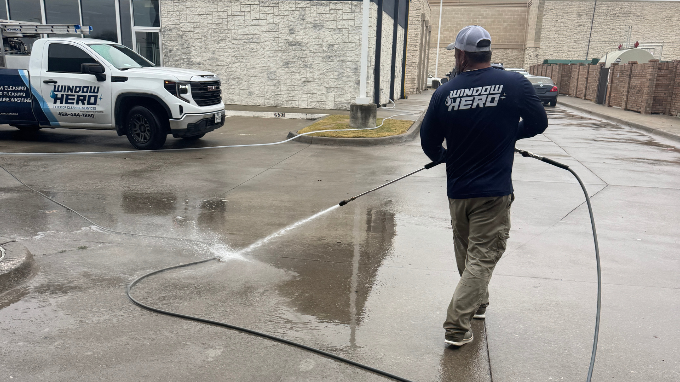 Window Hero professional cleaning a parking lot.