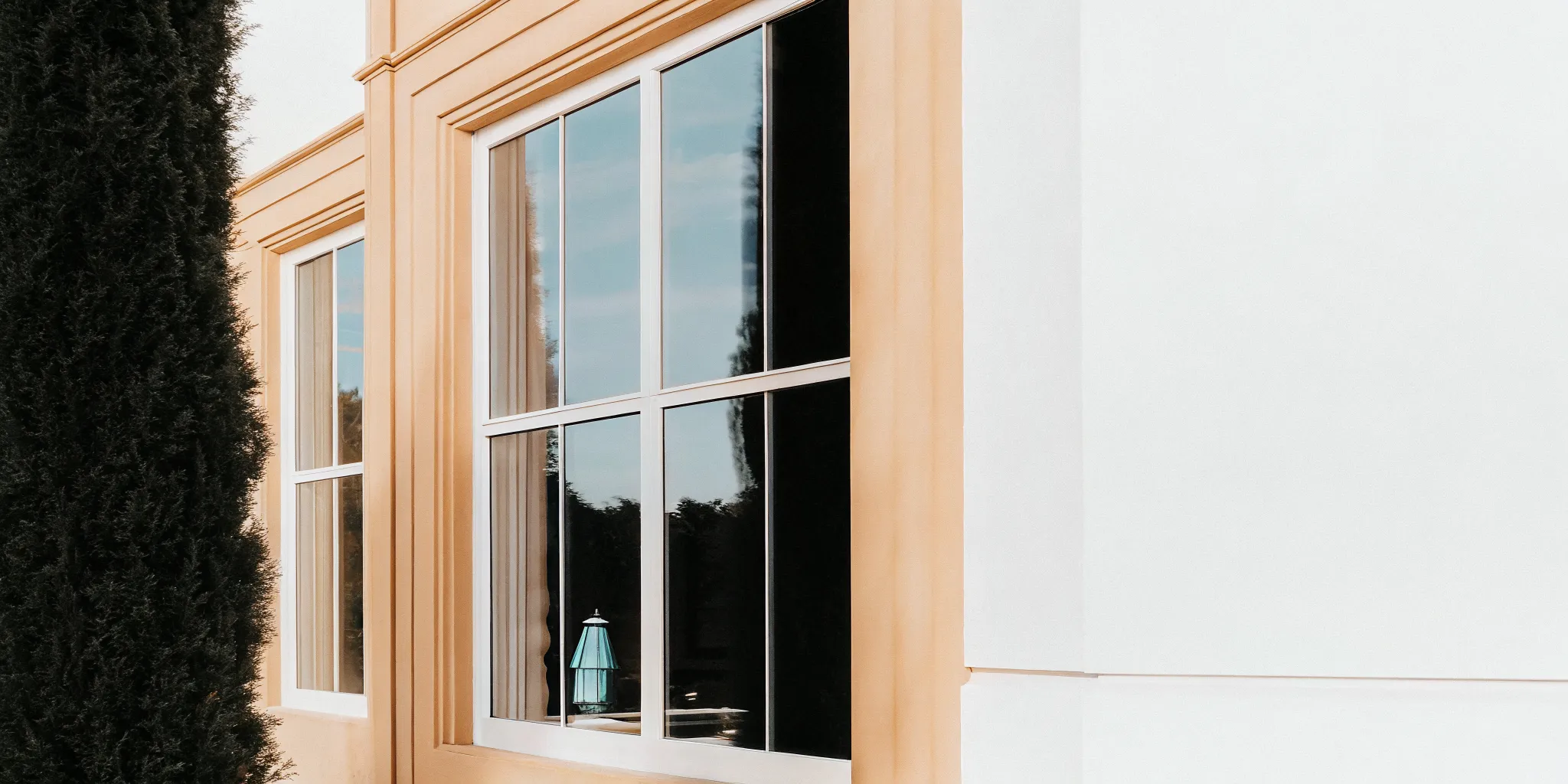 Professional window cleaner washing windows on a modern Southlake Texas home with streak-free results