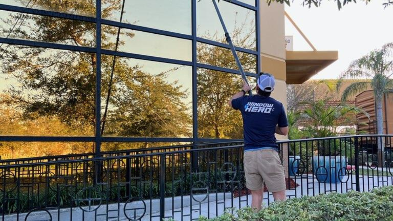 Window cleaning professional cleaning an office building.
